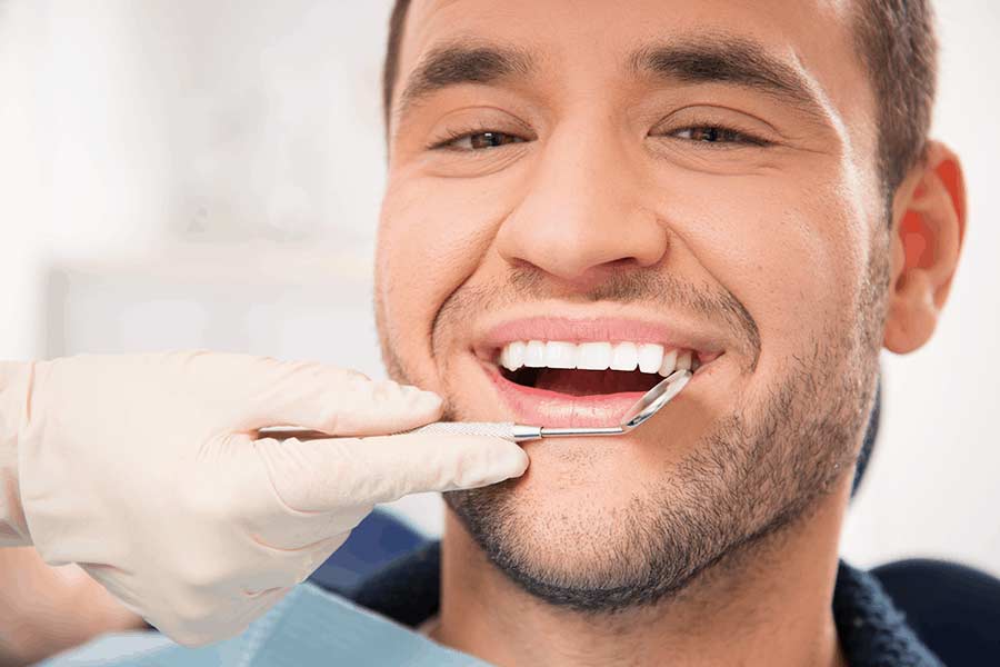 Smiling man after treatment at the local family dentist care & emergency dentistry in San Marcos