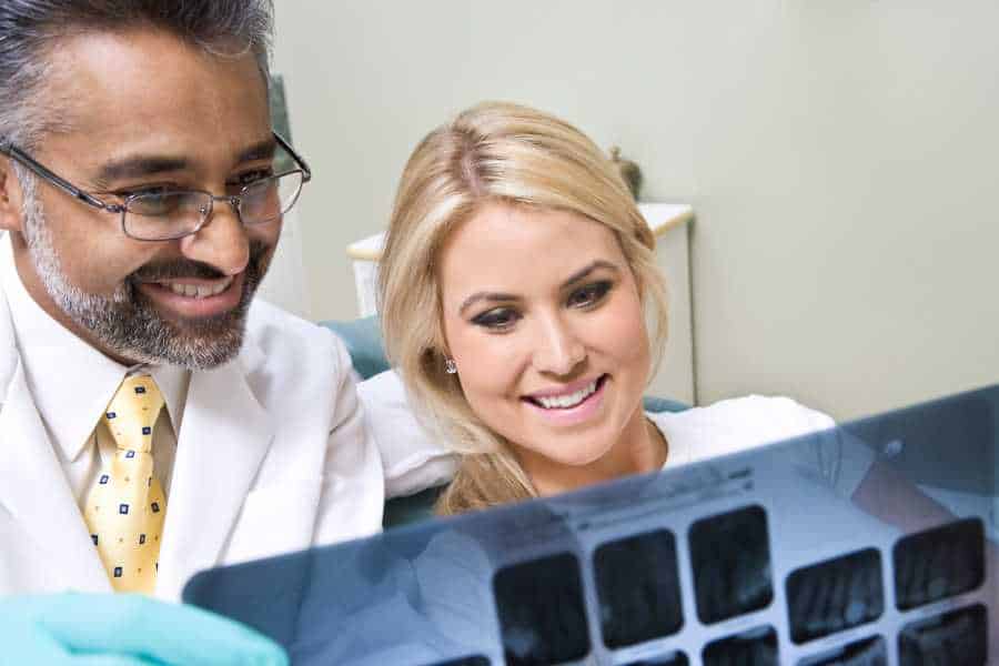 San Marcos dentist and patient looking at x-rays - Pediatric Dentist Office in San Marcos, TX